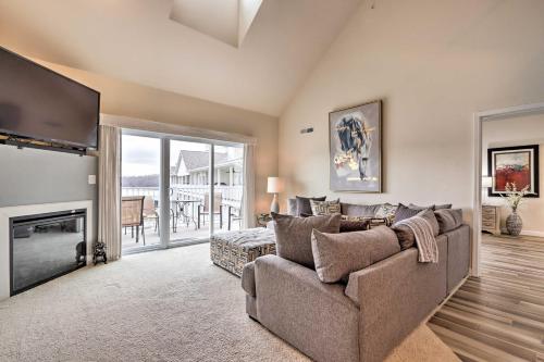 a living room with a couch and a television at Private Boat Slip Lake-View Osage Beach Getaway! in Osage Beach