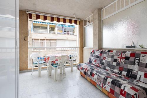 a living room with a table and a couch at Studio Playa del Cura in Torrevieja