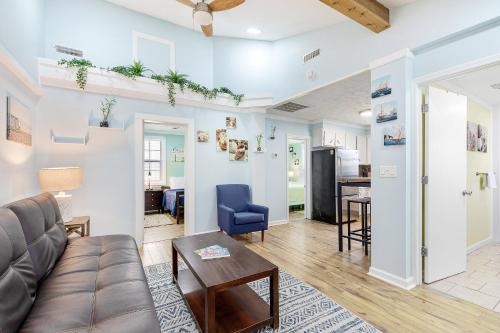a living room with a couch and a table at 23 Center St - Sunny Side Up - Upstairs Apartment in Folly Beach
