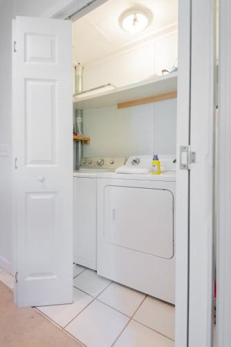 a kitchen with white cabinets and a sink at 306 E Arctic Ave. in Folly Beach