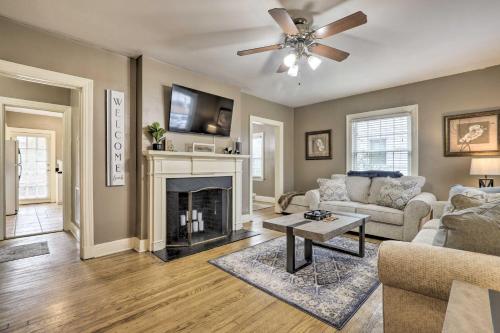 a living room with a couch and a fireplace at Chic and Cozy Greensboro Home, 2 Mi to Dtwn! in Greensboro