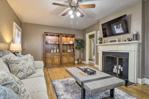 a living room with a couch and a fireplace at Chic and Cozy Greensboro Home, 2 Mi to Dtwn! in Greensboro