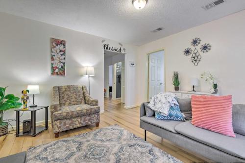 a living room with a couch and a chair at Stunning Gulfport Getaway about 1 Mi to the Beach in Gulfport
