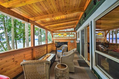 a screened porch with chairs and a fireplace in a tiny house at Fish, Crab and Clam Waterfront Gem in Port Ludlow in Port Ludlow