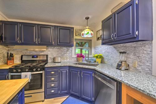 a kitchen with blue cabinets and granite counter tops at Fish, Crab and Clam Waterfront Gem in Port Ludlow in Port Ludlow