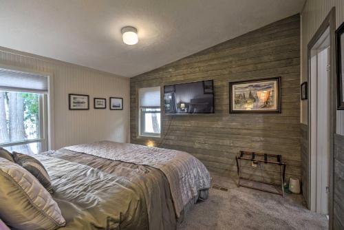 a bedroom with a bed and a tv on the wall at Fish, Crab and Clam Waterfront Gem in Port Ludlow in Port Ludlow