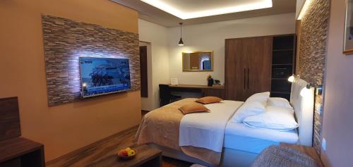 a bedroom with a bed and a brick wall at Villa Cardak in Mostar