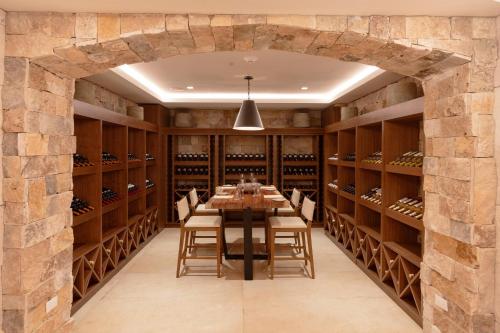 a dining room with a table and chairs and a stone wall at Sun Palace - All Inclusive Adults Only in Cancún
