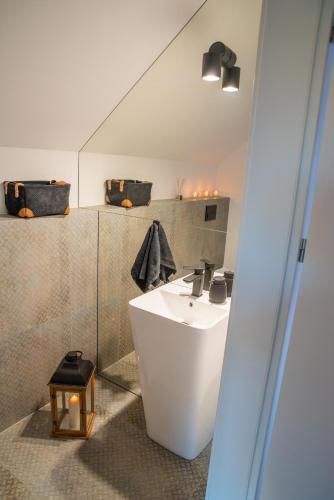 a bathroom with a white sink and a shower at Źródło Energii in Małastów