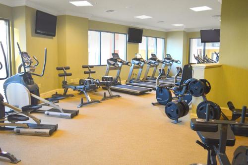 a gym with a bunch of treadmills and exercise bikes at Emerald Grande 922 in Destin