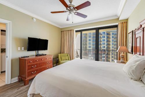 a bedroom with a bed and a flat screen tv at Emerald Grande 922 in Destin