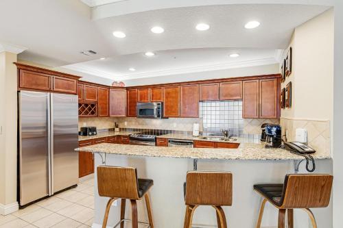 a kitchen with wooden cabinets and stainless steel appliances at Emerald Grande 922 in Destin
