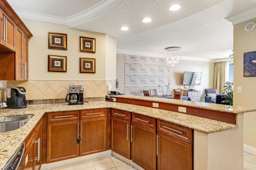 a kitchen with wooden cabinets and a counter top at Emerald Grande 922 in Destin
