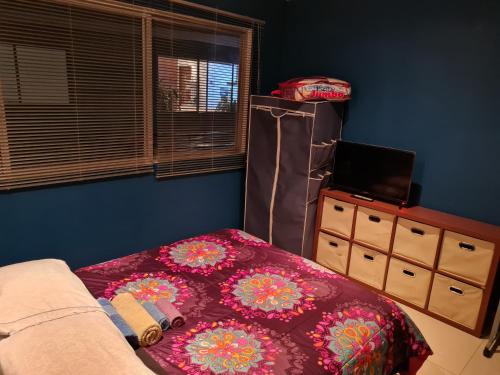 a bedroom with a bed and a tv and a window at Division del Norte Rooms in Mexico City
