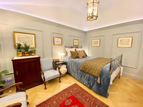 a bedroom with a bed and a couch and a chair at Old Riga Designer Luxury Apartment in Rīga