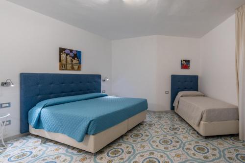 a bedroom with a blue bed and a mattress at Park Hotel Villa Maria in San Menaio