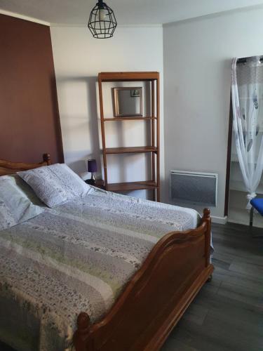 a bedroom with a bed and a book shelf at Maison individuelle avec jardin Sud Ardèche, Aubenas Vals les bains in Aubenas