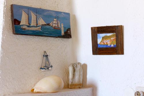 a wall with two pictures of sail boats on it at Villa Oleander in Spetses