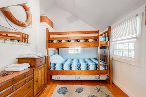 a bedroom with two bunk beds and a desk at Ocean Point Oasis in Mashpee