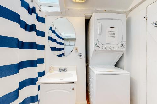 a bathroom with a sink and a mirror at Ocean Point Oasis in Mashpee
