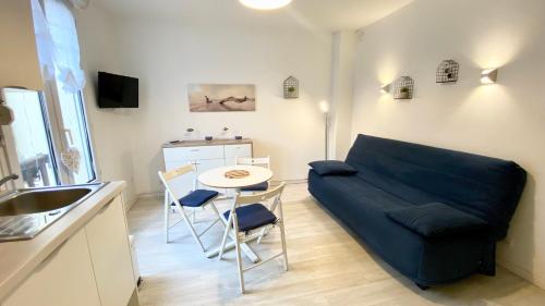 a living room with a couch and a table at La Parenthèse in Le Crotoy