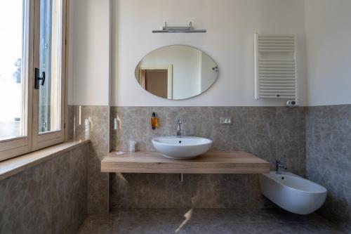 a bathroom with a sink and a mirror at Park Hotel Villa Maria in San Menaio