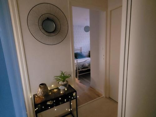 a hallway with a table and a mirror on the wall at chambre d'hôte chez Mimidid in Le Landreau