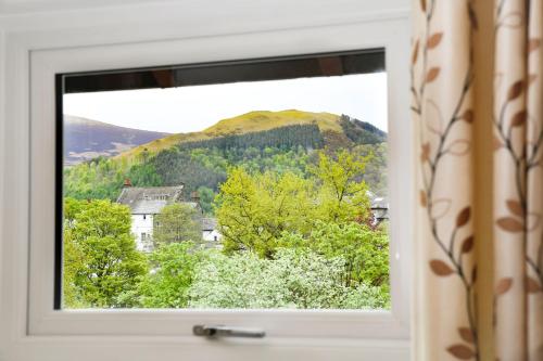 a window with a view of a mountain at West View in Keswick