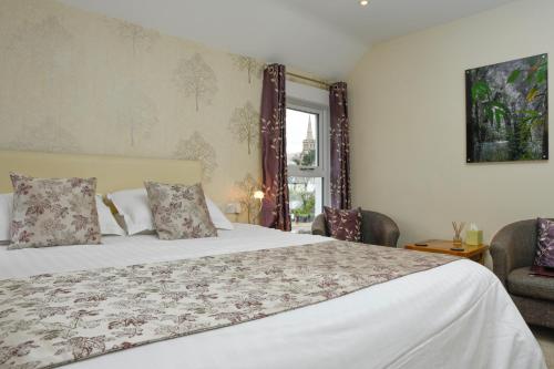 um quarto com uma cama grande e uma janela em West View em Keswick