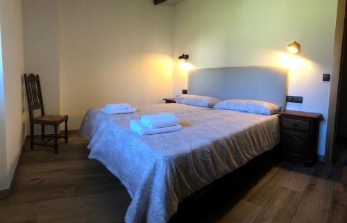 a bedroom with a large bed with towels on it at Urruti in Zilbeti