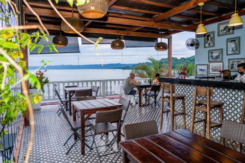フローレスにあるHotel Casona de La Islaのテーブルと椅子とバーのあるレストラン