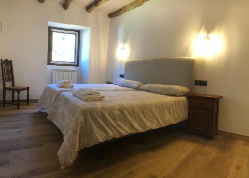 a bedroom with a large bed with towels on it at Urruti in Zilbeti