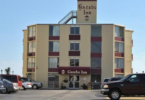 a large building with cars parked in a parking lot at Gazebo Inn Oceanfront in Myrtle Beach