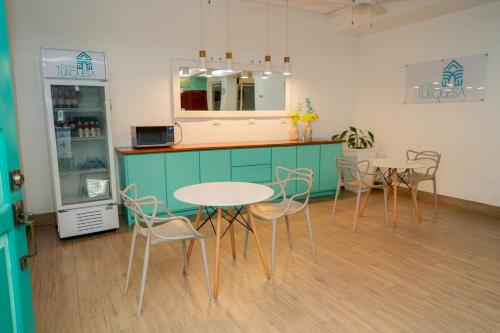 a restaurant with tables and chairs and a counter at Hotel Casa Turquesa in Flores