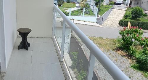 a balcony with a table on the side of a building at Pousada Floresta in Joinville