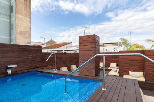 a swimming pool on top of a building at Holiday Rentals Tempa Museo in Seville