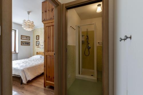 um quarto com uma cama e uma casa de banho com um espelho. em Solaia em Mazzin