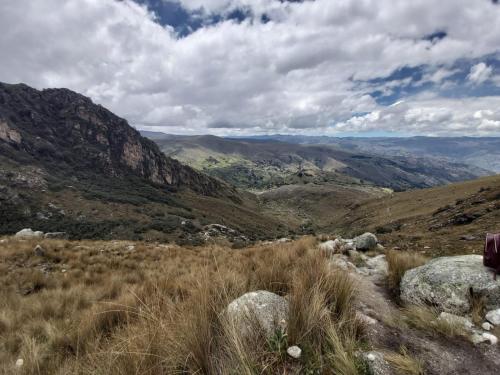 a view of a mountain with tall grass and rocks at Hospedaje apus in Huaraz