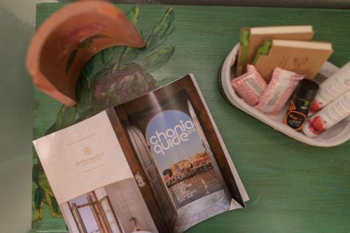 a table with a magazine and a box of candy at Villa Georgia in Kalyves