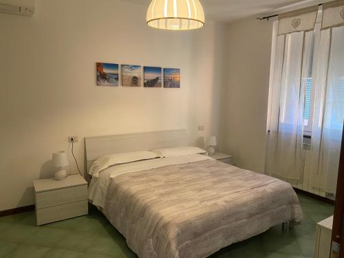 a bedroom with a large bed and a chandelier at Smeraldo in Levanto