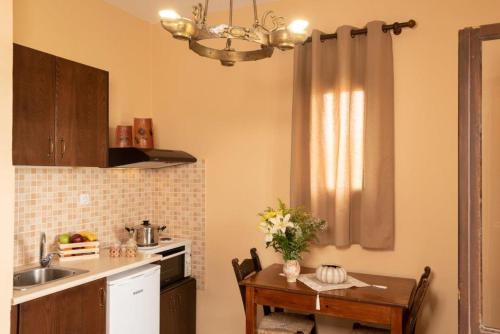 a kitchen with a table and a sink and a dining room at Villa Georgia in Kalyves