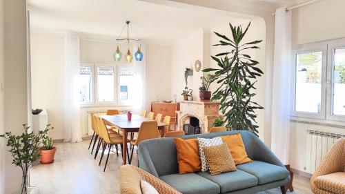 a living room with a blue couch and a table at Villa D'Uvale Douro in Alijó