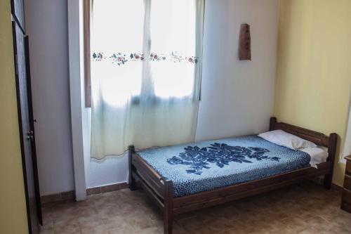 a small bed in a room with a window at Villa Georgia in Kalyves