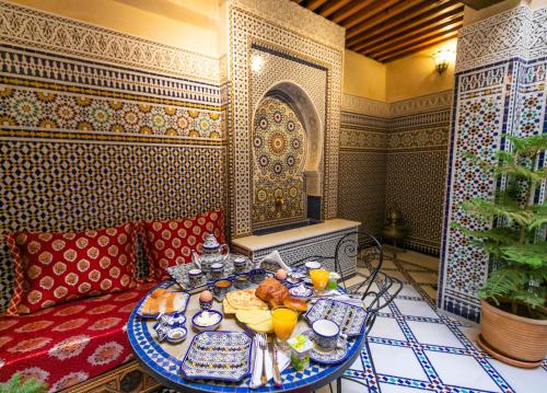 a table with a plate of food on it at Guesthouse Dar Othmane in Fez