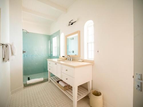 a bathroom with a sink and a mirror at Windjammer Landing Resort and Residences in Gros Islet
