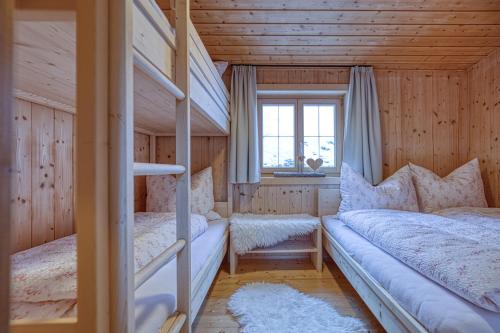 a bedroom with two bunk beds and a window at Nüggili's Maisäß in Tschagguns