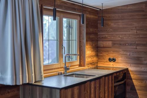 a kitchen with a sink and a window at Nüggili's Maisäß in Tschagguns