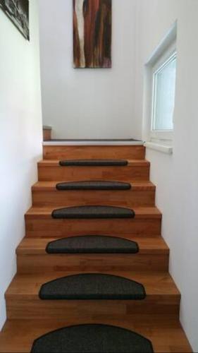a wooden staircase with four cushioned at Ferienwohnungen Sammer in Strobl