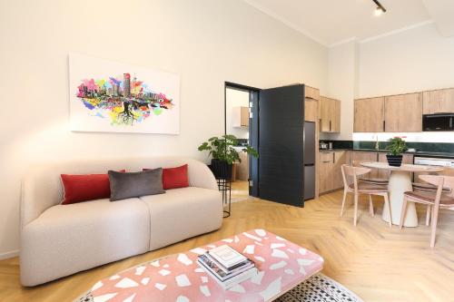 a living room with a couch and a kitchen at Hyatt House Johannesburg Rosebank in Johannesburg