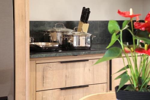 a kitchen counter with pots and pans on a stove at Hyatt House Johannesburg Rosebank in Johannesburg